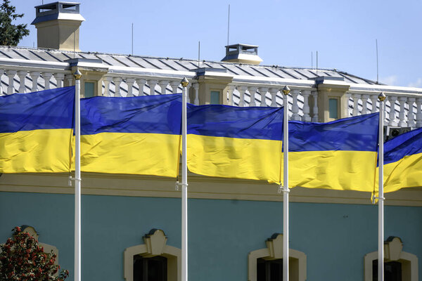 Ukrainian national flags wave on flagpoles near the Mariinsky Palace in Kyiv during Ukraine Independence Day celebrations on August 24, 2025. High quality photo