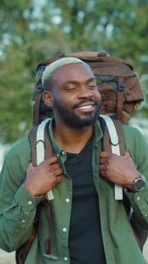 Sırt çantasıyla şık, maceraperest bir insan, doğanın güzelliğine kendini tamamen kaptırmış ve takdir ediyor.