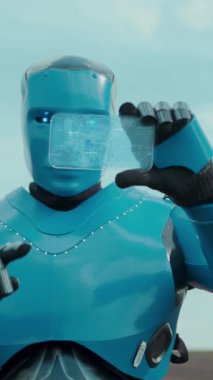 Parlak mavi bir robot, açık bir gökyüzü arkaplanına karşı dostça bir selam veriyor, ileri teknoloji somutlaştırıyor.