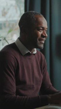 Bilgisayarda oturup iyi haberlerle mesaj okuyan mutlu duygusal bir adamın portresi. Ofiste monitör önünde çalışan neşeli iş adamının görüntüsü. İçeride. Uzak görev