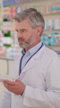 Portre yakışıklı, neşeli eczane danışmanı yetişkin yetişkin üzerinde ilaç paketi ve bilgisayar var. Eczacı portresi. Tıp sektörü.