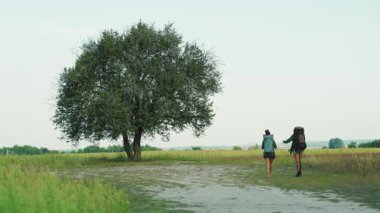 Afrikalı safari çifti, güzel savanalarda gezen turist sırt çantalı evli adam ve kadın, fauna ve floranın tadını çıkarıyorlar. Eğlence için. Turizm. Maceralar.