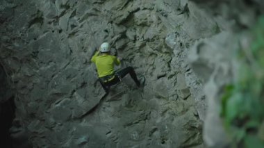 Kask takan aktif dağcı sakallı adam dağ kayasına tırmanıyor. Doğa çevresi. Maceralar. Yaz tatili.