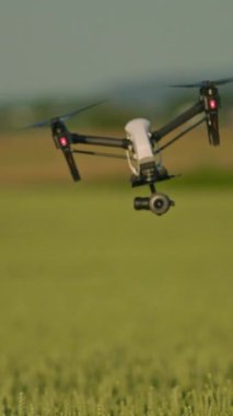 Yüksek performanslı bir dron verimli yeşil manzaraların üzerinde uçuyor, doğa ve teknoloji görselleri için ideal..