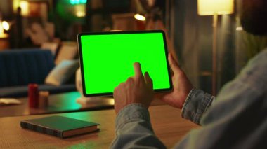 Elinde kaydırma ve yatay yeşil ekranla tablet bilgisayarına tıklama görüntüsü. Model yap. Karanlık oda