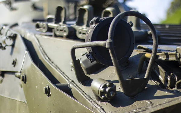 stock image Front headlight with battle tank protection. Very bright searchlight on the tank turret, close-up. Armored infantry fighting vehicle. Fragment of an old armored personnel carrier, khaki headlight