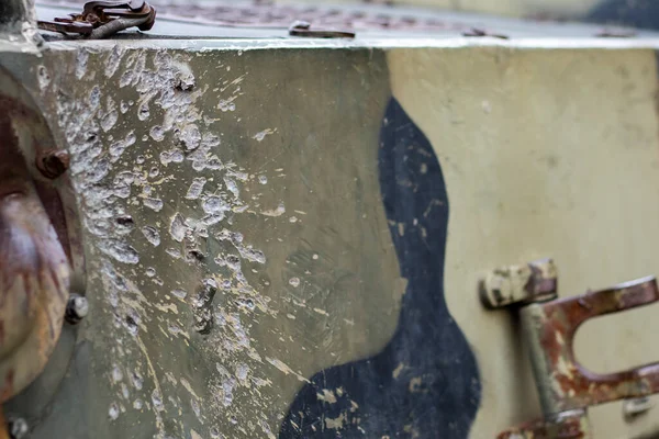 Stock image Hole or hole, armor deformation from a projectile close-up. Damaged armor of a Russian armored personnel carrier by shell fragments. War in Ukraine. Russian combat vehicle with holes in the armor