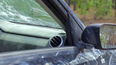 Bullet hole in a car door. Abandoned car with bullet holes. A destroyed vehicle in a war zone in Ukraine. Damaged civilian car. The car was damaged by shrapnel as a result of hostilities