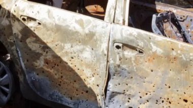 A lot of rusty burnt cars in the city of Irpin. War of Russia against Ukraine. Destroyed cars of civilians who were evacuated from the combat zone. The result of a fire. Auto insurance concept