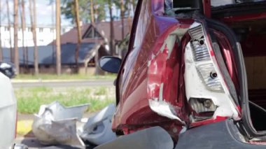 Red car after a terrible accident on the side of the road. Frontal and side impact. Life insurance. An accident without the possibility of recovery. Back view. Damage after an accident