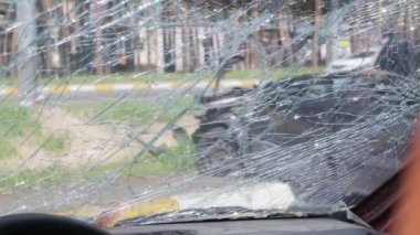 Cracked car windshield after an accident. Close-up of a wrecked vehicle after a collision with a pedestrian or car accident. Damaged vehicle. Road safety, car insurance. View from inside the cabin