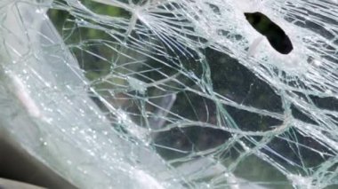 Cracked car windshield after an accident. Close-up of a wrecked vehicle after a collision with a pedestrian or car accident. Damaged vehicle. Road safety, car insurance. View from inside the cabin