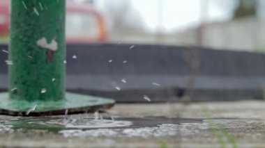 Falling water drop. Use of water resources. Splashes of water. Drops falling from the tap on the street in slow motion. Daylight, close-up. Selective focus