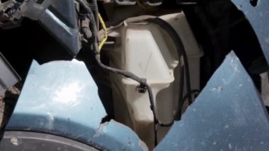 Broken car after an accident. The body of a car is damaged in a severe car accident after a collision at the scene of an accident on a city street. The concept of road safety and insurance