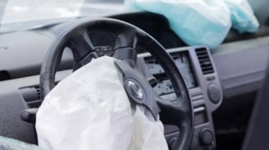 Focus on the steering wheel of the car and the deployed airbag. Airbag on the drivers side on the wheel after a car accident. Panorama. Drivers side airbag. Ukraine, Irpin - May 12, 2022