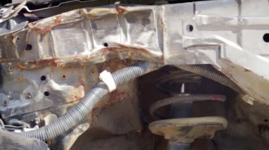 Black passenger car without front left fender. Car after an accident. Close-up of a disassembled car for repairs at a service station. Car service concept. Vehicle after an accident