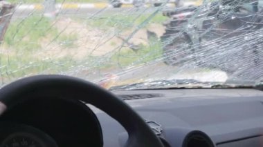 Cracked car windshield after an accident. Close-up of a wrecked vehicle after a collision with a pedestrian or car accident. Damaged vehicle. Road safety, car insurance. View from inside the cabin