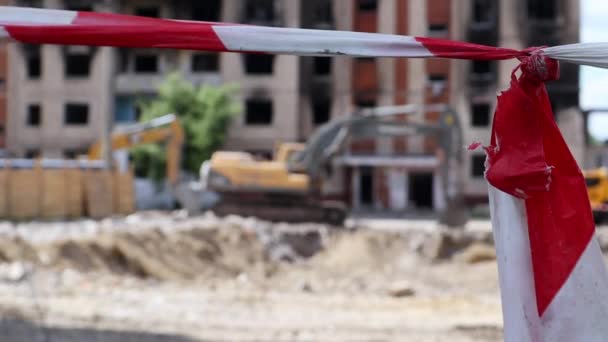 拆卸多层公寓的建筑工程 用红白相间的警戒线构成的栅栏 拆卸住宅时采用液压破碎机的挖掘机 — 图库视频影像