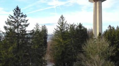 Uetliberg TV tower between forest at hazy day in wintertime near Zrich.