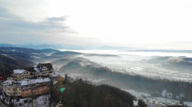 Drone view from Uetliberg with steel framework tower and restaurant on top and the landmark of Zurich's local mountain. It's one of the highest publicly accessible lookout towers in Switzerland.
