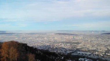 Drone view from Uetliberg with concrete tower at hazy winter day on top of Zurich's local mountain. View to Zurich City and canton Aargau.
