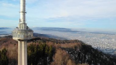 Drone view from Uetliberg with concrete tower at hazy winter day on top of Zurich's local mountain. View to Zurich City and canton Aargau.