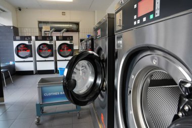 Bozuk para yıkamak için umumi çamaşırhanedeki açık çamaşır makinesini kapat..
