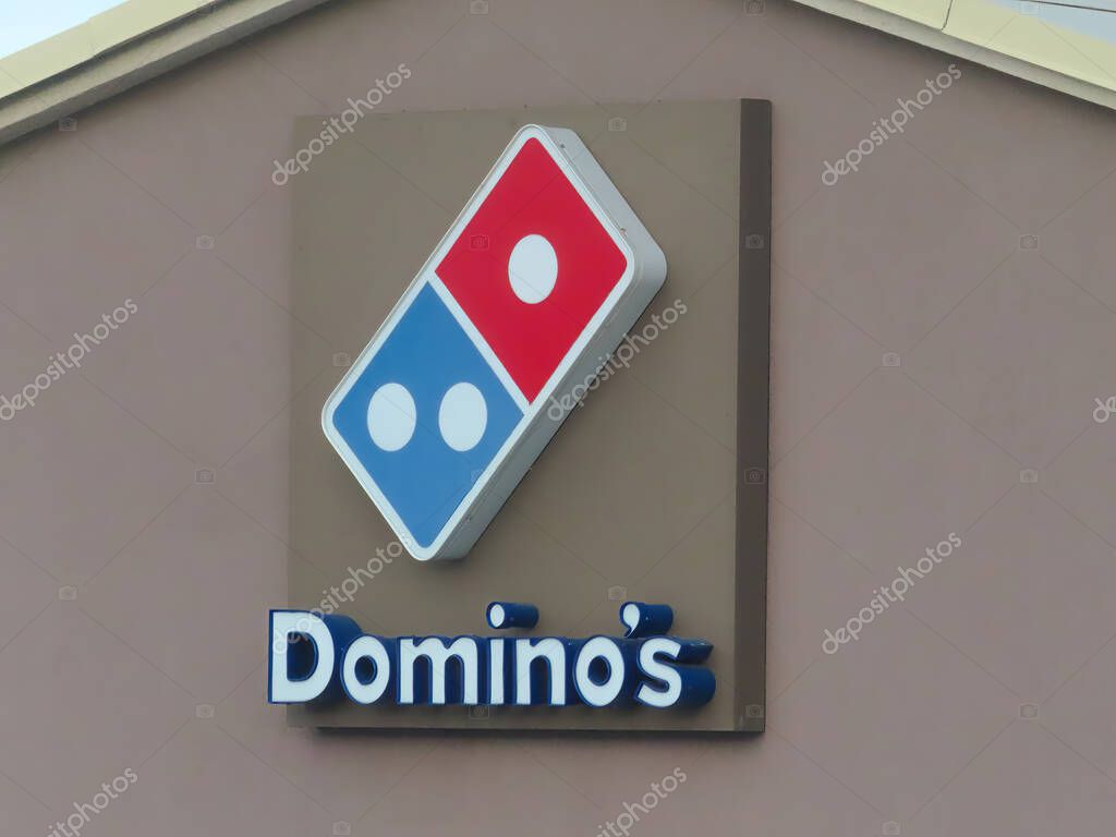 Nov 23, 2022. Calgary, Alberta, Canada. A Dominos Pizza sign at a store.