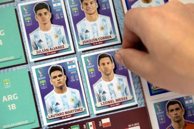 8 Aralık 2022. Calgary, Alberta, Kanada. Futbol fanatiği Fifa Dünya Kupası albümüne Arjantinli bir Panini çıkartması ekliyor..