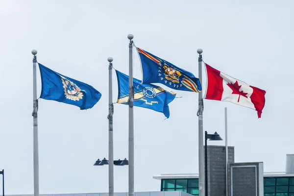Flags of the Alberta Emergency Medical, Police and Fire Fighters Services with a Canadian Flag
