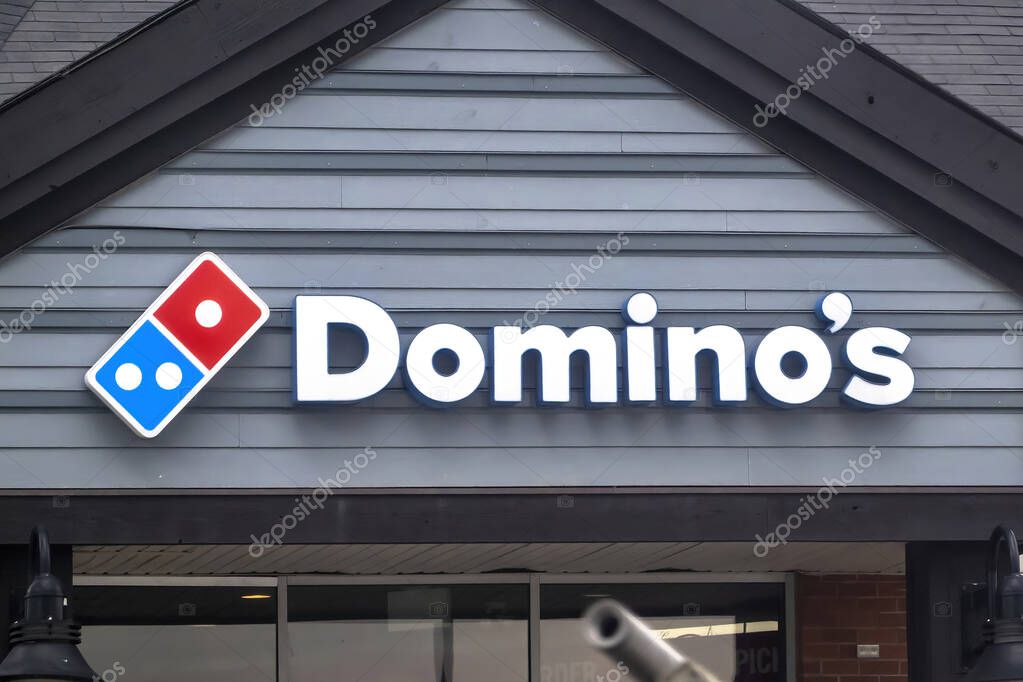 Calgary, Alberta, Canada. May 17, 2023. A Dominos Pizza restaurant entrance.