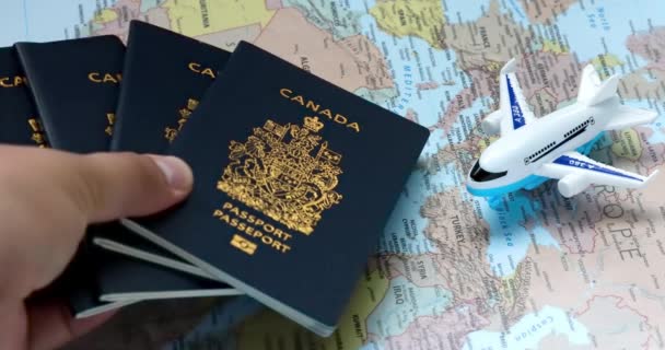 Alberta Canada Aug 2023 Person Dropping Canadian Passports World Map — Stock Video