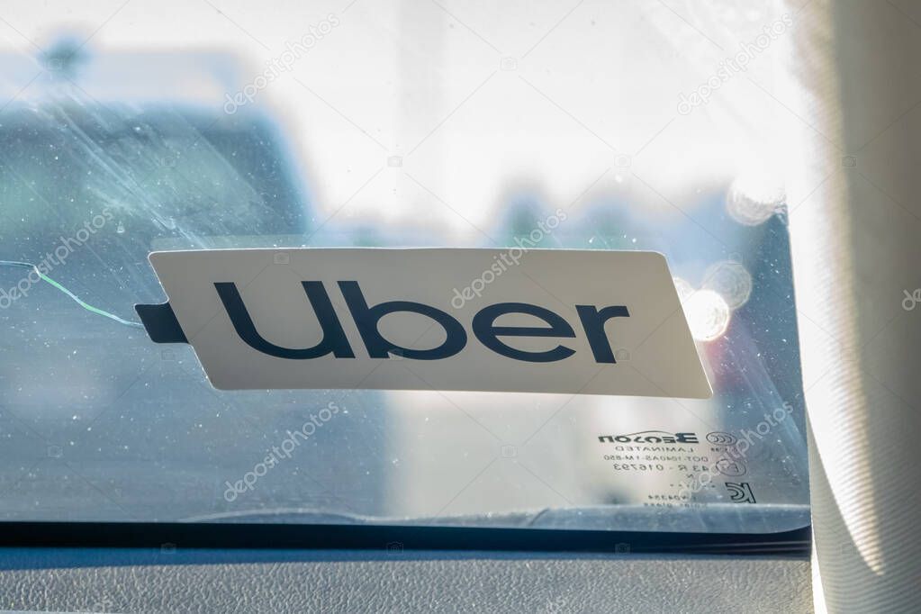 Calgary, Alberta, Canada. Feb 18, 2024. A close-up of an Uber decal affixed inside a vehicle.