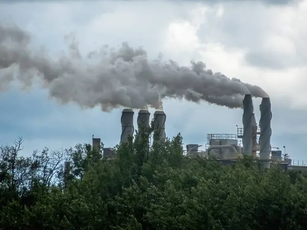 stock image Calgary, Alberta, Canada. Jun 17, 2024. Chimneys Producing gas emissions from the Johns Manville fiberglass insulation plant.