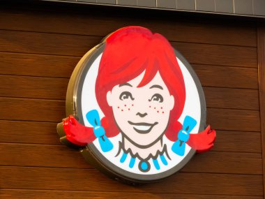 Calgary, Alberta, Canada. Oct 31, 2024. The logo of Wendy's displayed prominently on a restaurant wall. clipart