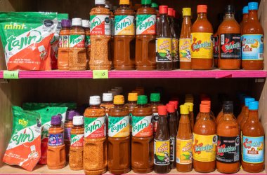 Cabo, B.C.S. Meksika mı? 22 Kasım 2024. Tajin, Valentina ve La Huichol da dahil olmak üzere çeşitli Meksika acı sos ve acı biber tozlarıyla dolu bir raf. Şişeler ve paketler düzgünce düzenlenmiş..