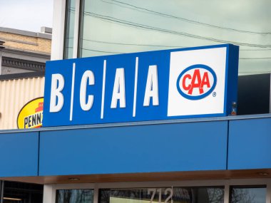 Victoria, British Columbia, Canada. Feb 11, 2025. A bright blue sign displays BCAA in bold white letters, flanked by the iconic red Canadian Automobile Association logo. clipart