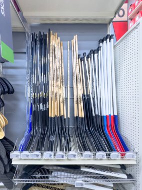 Calgary, Alberta, Kanada. 10 Nisan 2025. Perakende rafında marka ve boyutuna göre düzenlenmiş çeşitli hokey sopaları ve fiyat etiketleri yer almaktadır..