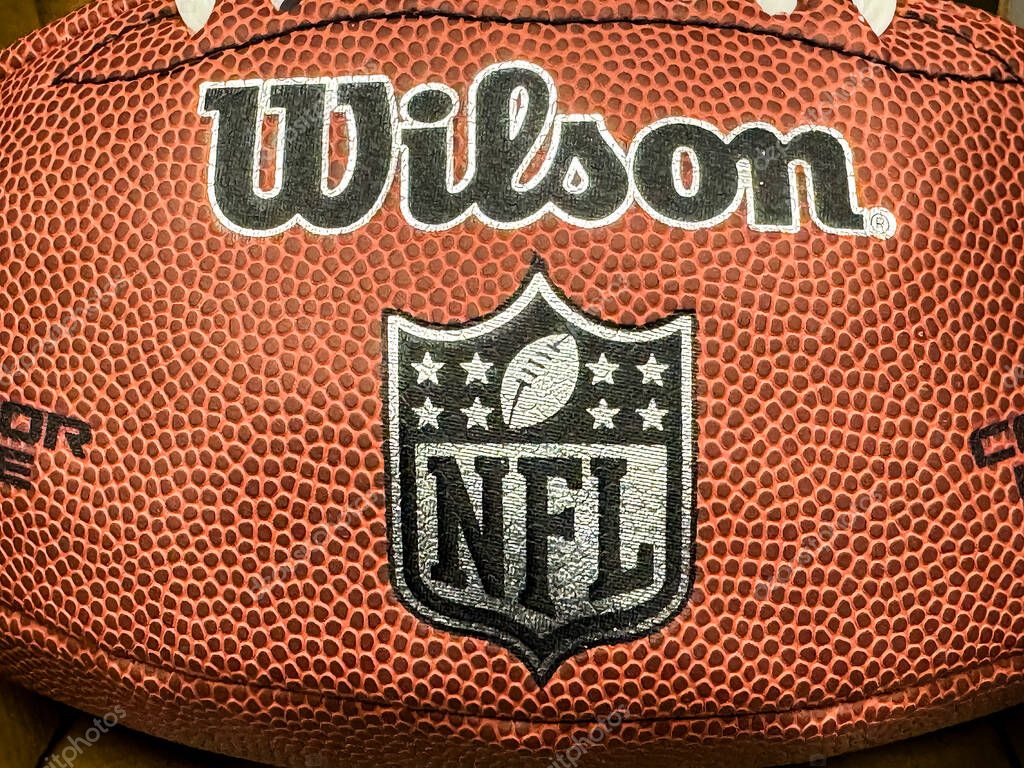 Calgary, Alberta, Canada. Apr 10, 2025. A close-up of a brown Wilson American football with white laces, prominently displaying the NFL shield and Wilson branding.