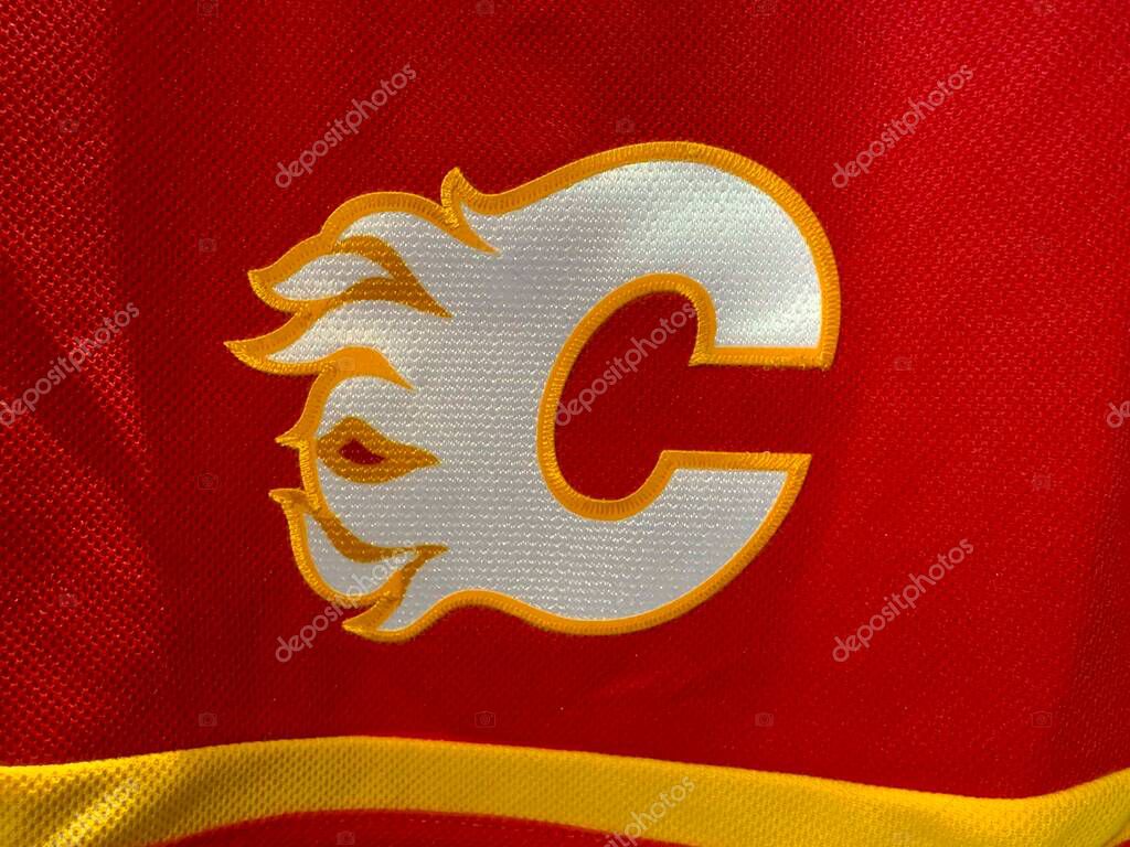 Calgary, Alberta, Canada. Apr 17, 2025. A close-up of the Calgary Flames hockey team logo prominently displayed on a red jersey or fabric.