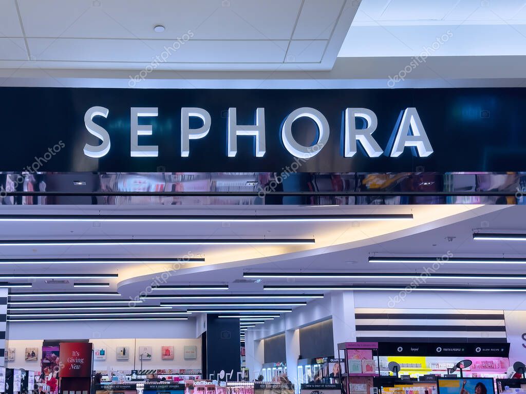Calgary, Alberta, Canada. Apr 16, 2025. A brightly lit SEPHORA store sign with white lettering on a dark background positioned above the entrance of the beauty retailer.