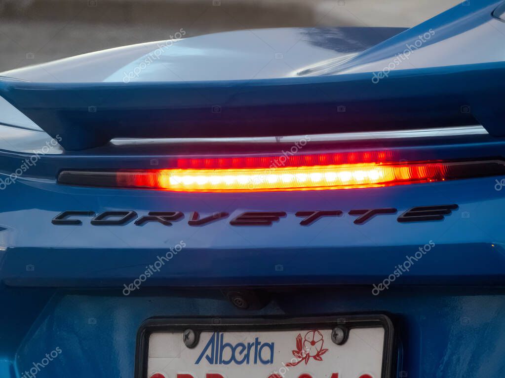 Calgary, Alberta, Canada. Apr 18, 2025. A close-up of the rear of a blue Chevrolet Corvette shows the illuminated brake light and the 