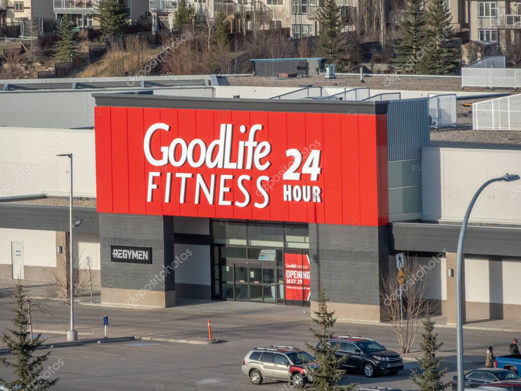 Calgary, Alberta, Canada. Apr 18, 2025. The exterior of a GoodLife Fitness center features a prominent red sign with white lettering indicating it's open 24 hours.