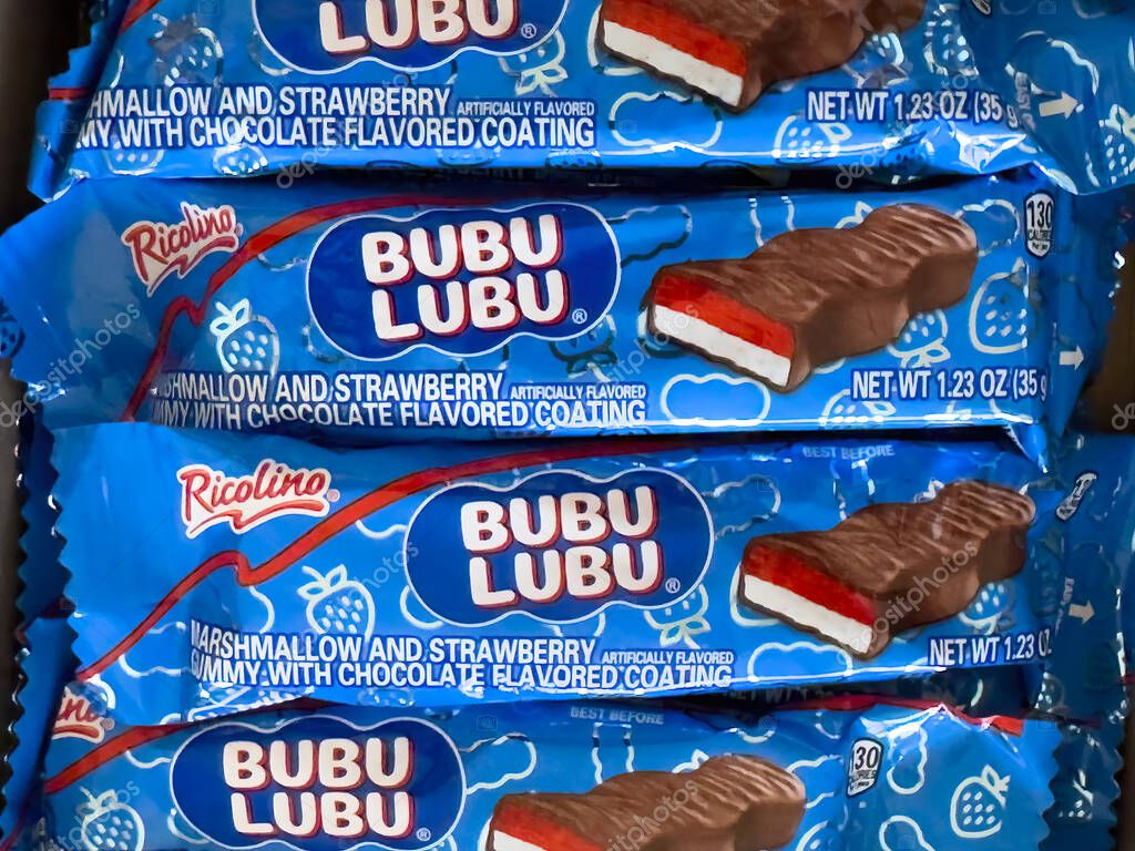 Calgary, Alberta, Canada. Apr 18, 2025. A stack of individually wrapped Ricolino Bubulubu candies, each featuring a chocolate-covered marshmallow and strawberry gummy, is shown in their blue packaging
