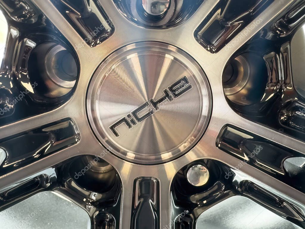 Calgary, Alberta, Canada. Apr 30, 2025. A Niche Snap-In wheel center cap with a gloss tinted finish and an anthracite logo centrally featured, showcasing its intricate design.