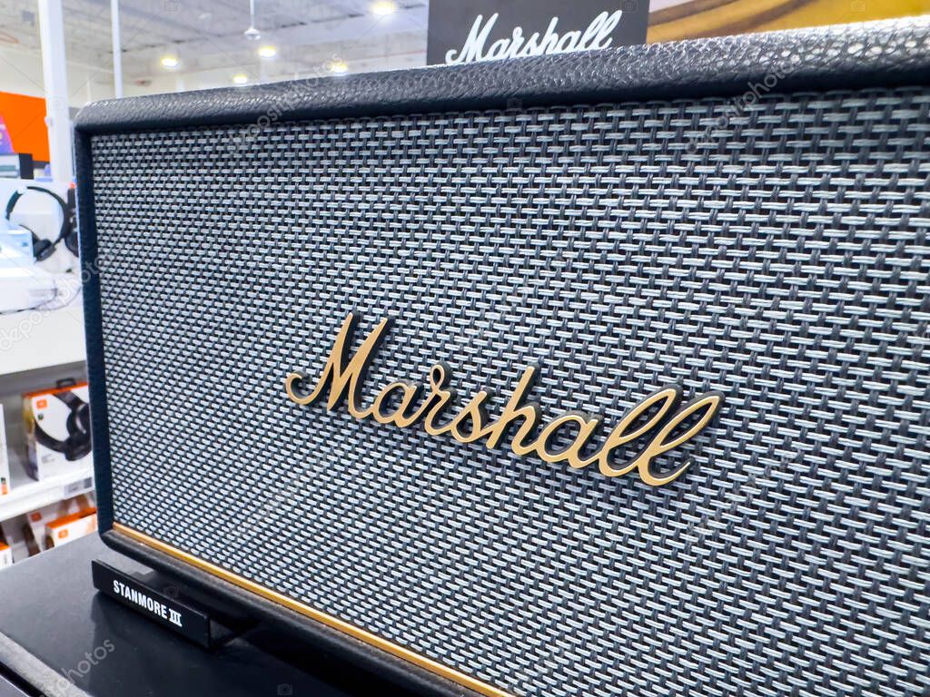 Calgary, Alberta, Canada. May 4, 2025. A close-up of a Marshall Stanmore III speaker showcases its textured grill cloth and the iconic gold Marshall script logo. The speaker is in a retail setting.