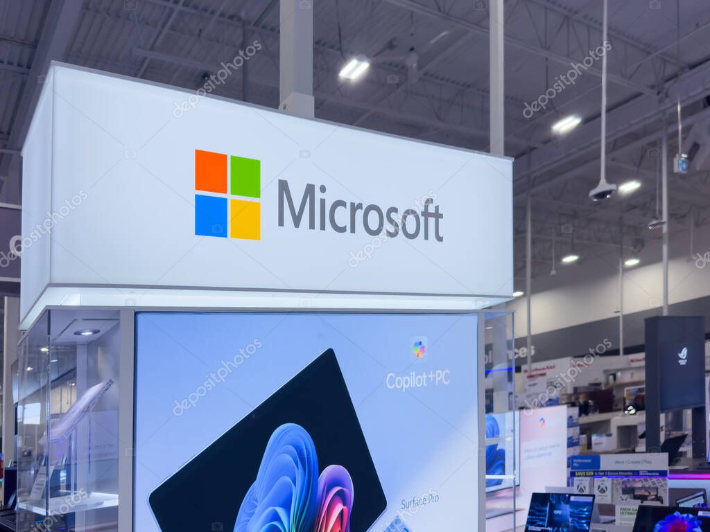 Calgary, Alberta, Canada. May 4, 2025. A brightly lit Microsoft display in a retail environment showcases Surface Pro devices and promotes 