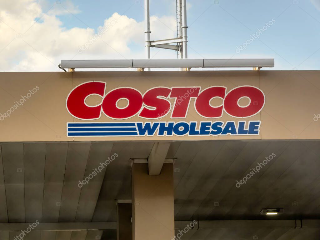 Calgary, Alberta, Canada. May 9, 2025. A prominent Costco Wholesale sign adorns a gas station canopy under a partly cloudy sky, representing the well-known retail brand.