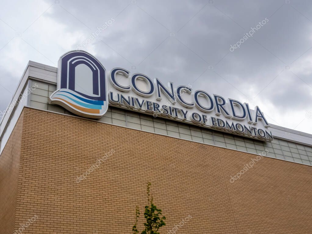 Edmonton, Alberta, Canada. May 21, 2025. The Concordia University of Edmonton logo, with its distinct arch and waves, proudly signifies a beacon of higher learning against a cloudy sky.