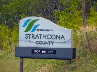 Strathcona County, Alberta, Kanada. 24 Mayıs 2025. Strathcona İlçesi 'nin hoş geldin tabelasında, yemyeşil bir zemin üzerine kurulmuş ilçe logosu ve nüfusu yer alıyor..